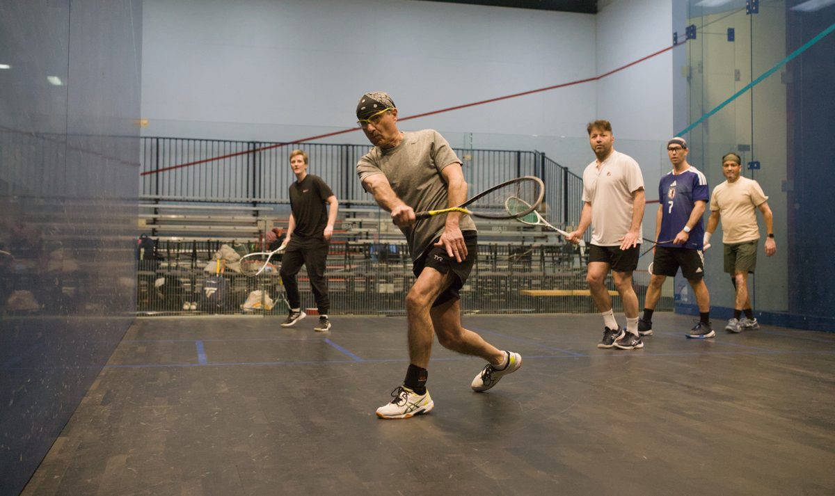 Reverse NSL: amateurs on court, pros coaching from the back wall