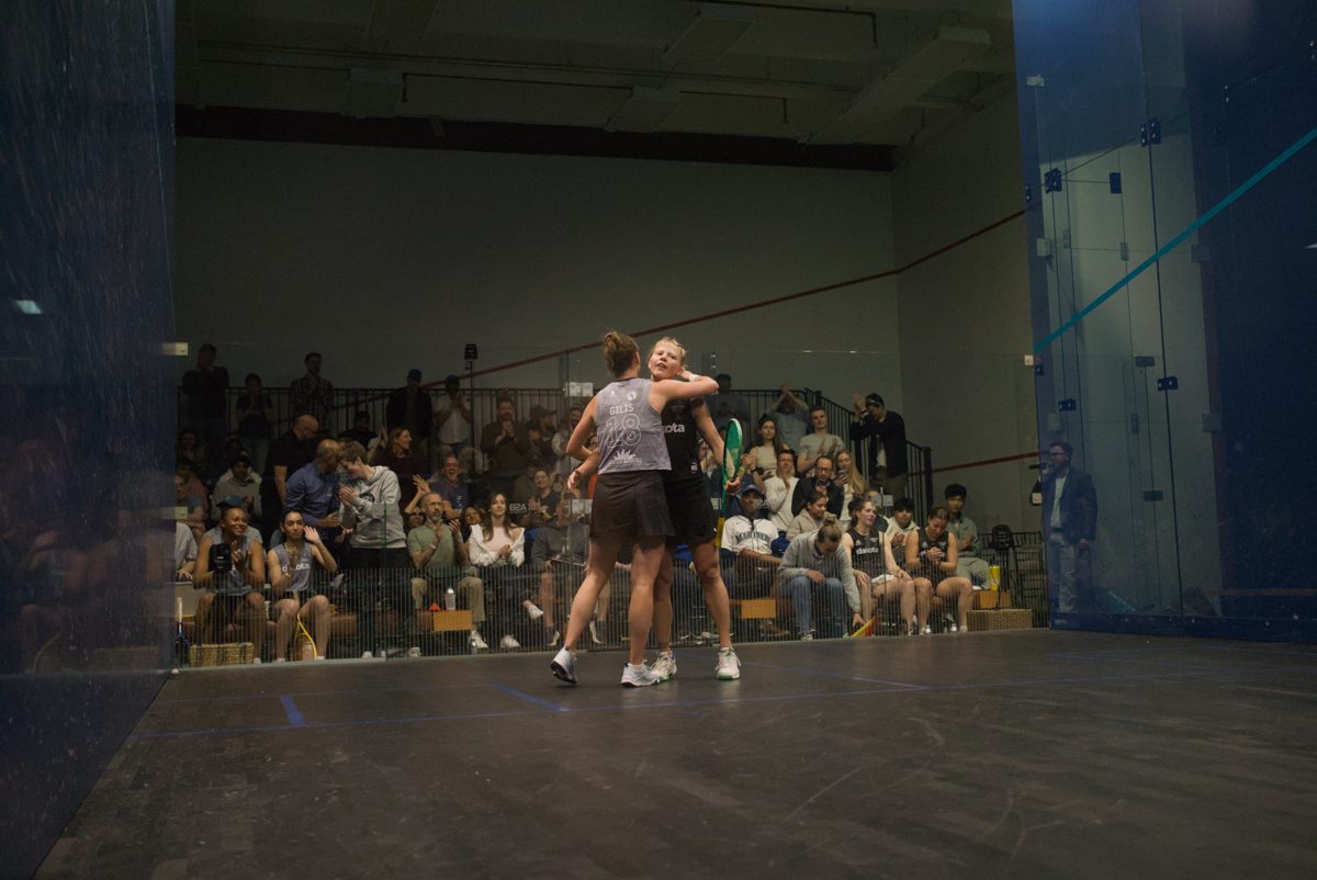 Players embrace after a match on the glass court